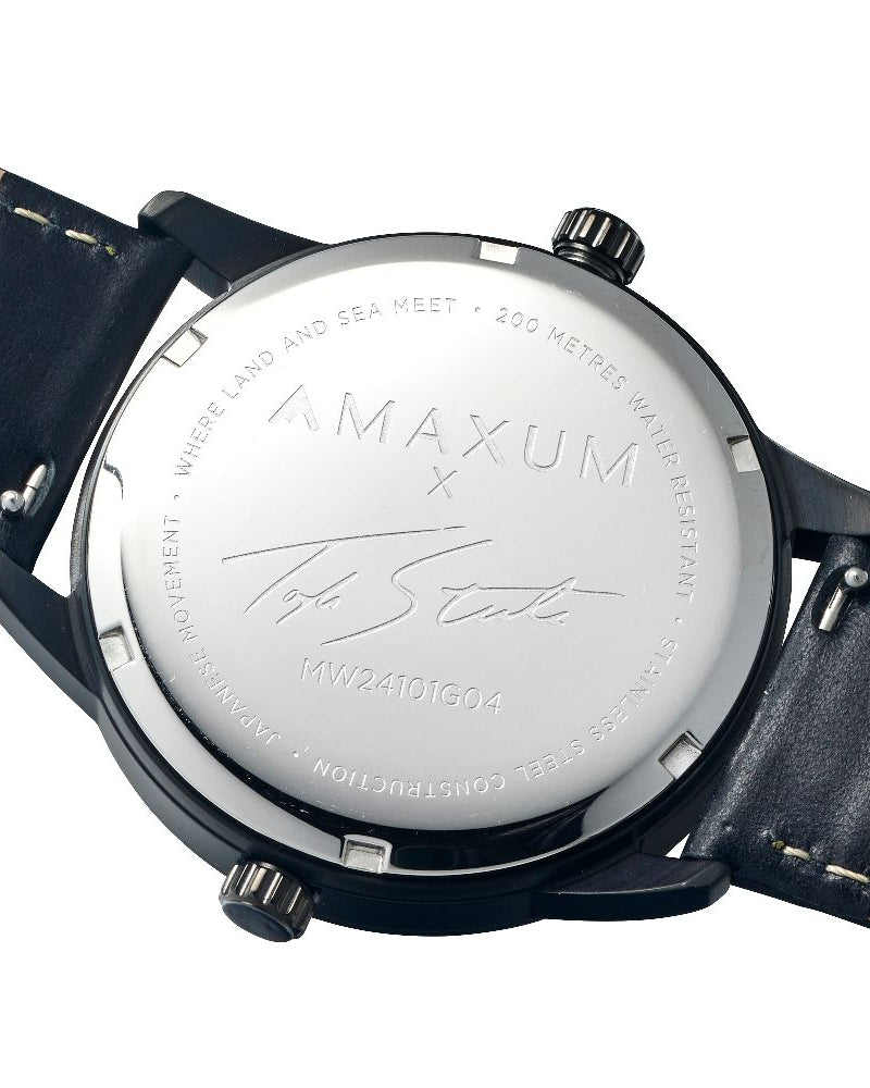 Maxum x Taylor Steele collab- black analog watch with a black dial, black case, and black leather band, back case engraving close up